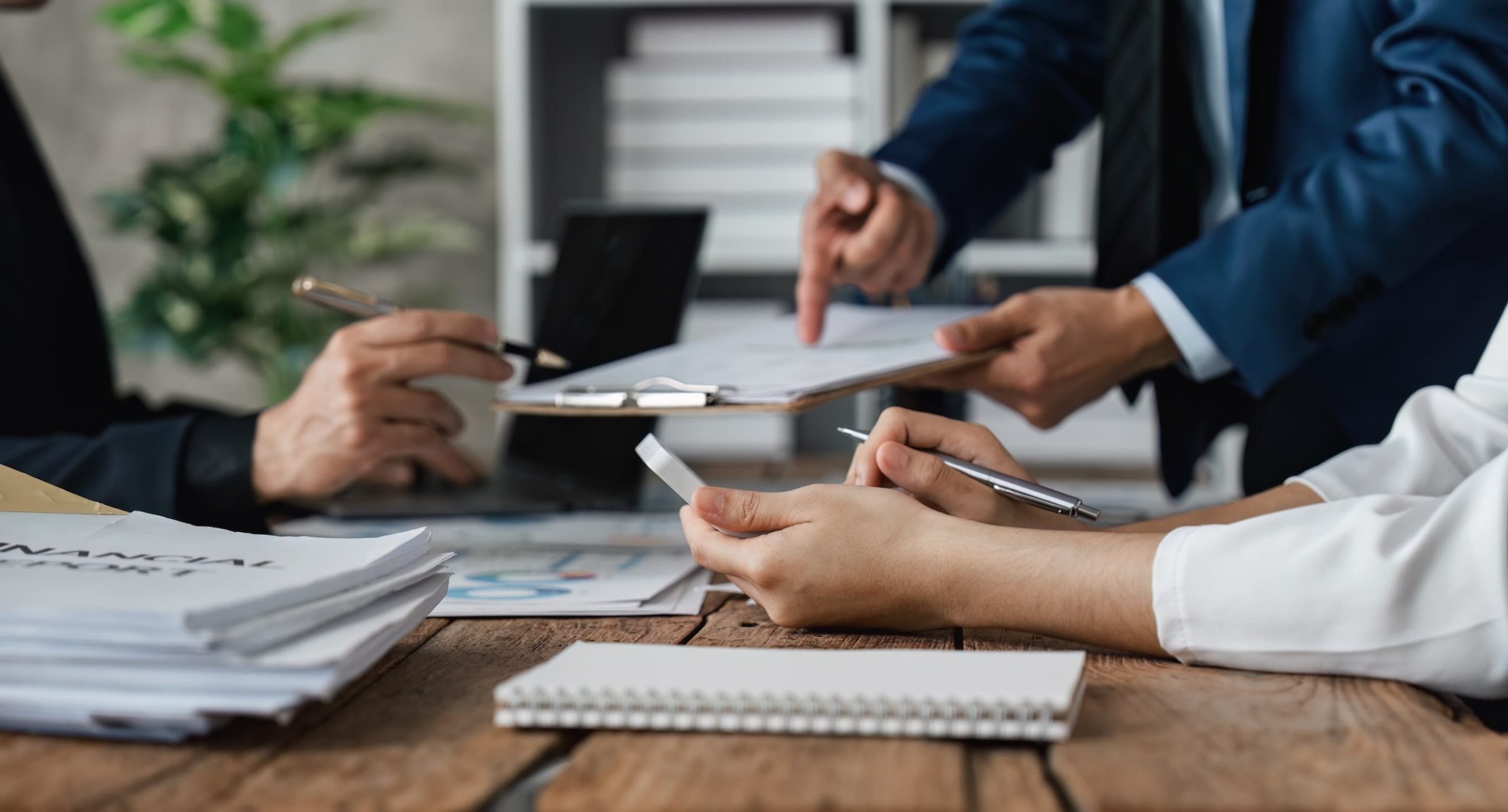 M&A Advisory Category - Closeup of hands of business team discussing a plan